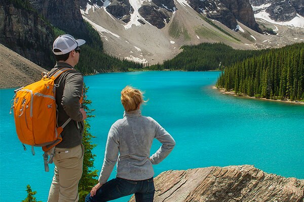 Man and woman enjoying view of a lake